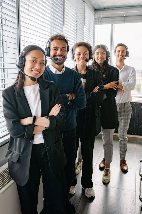 Colleagues wearing headsets working together in a professional support setting