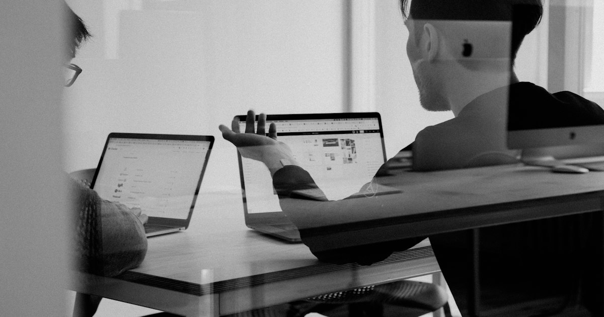 Customer support representative wearing a headset working at a computer in a modern office