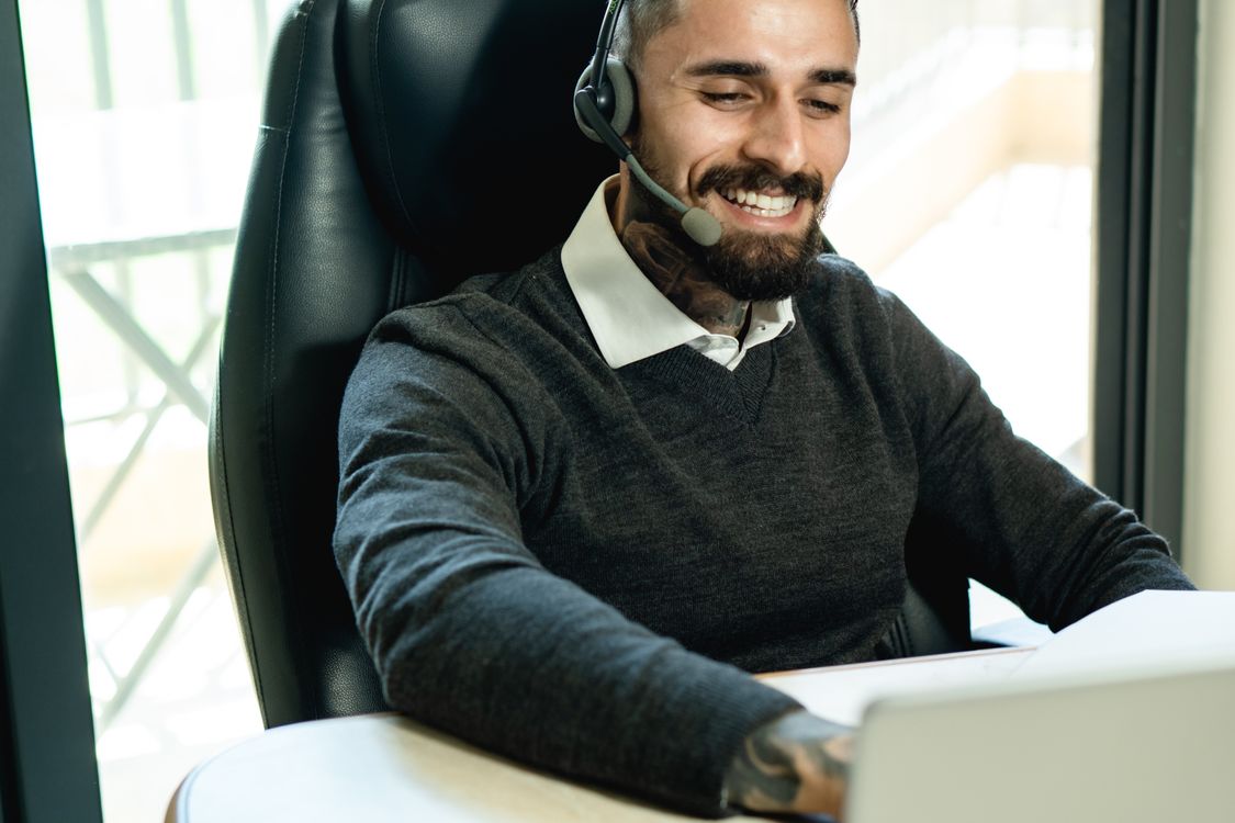 Customer service representative wearing a headset at an office desk