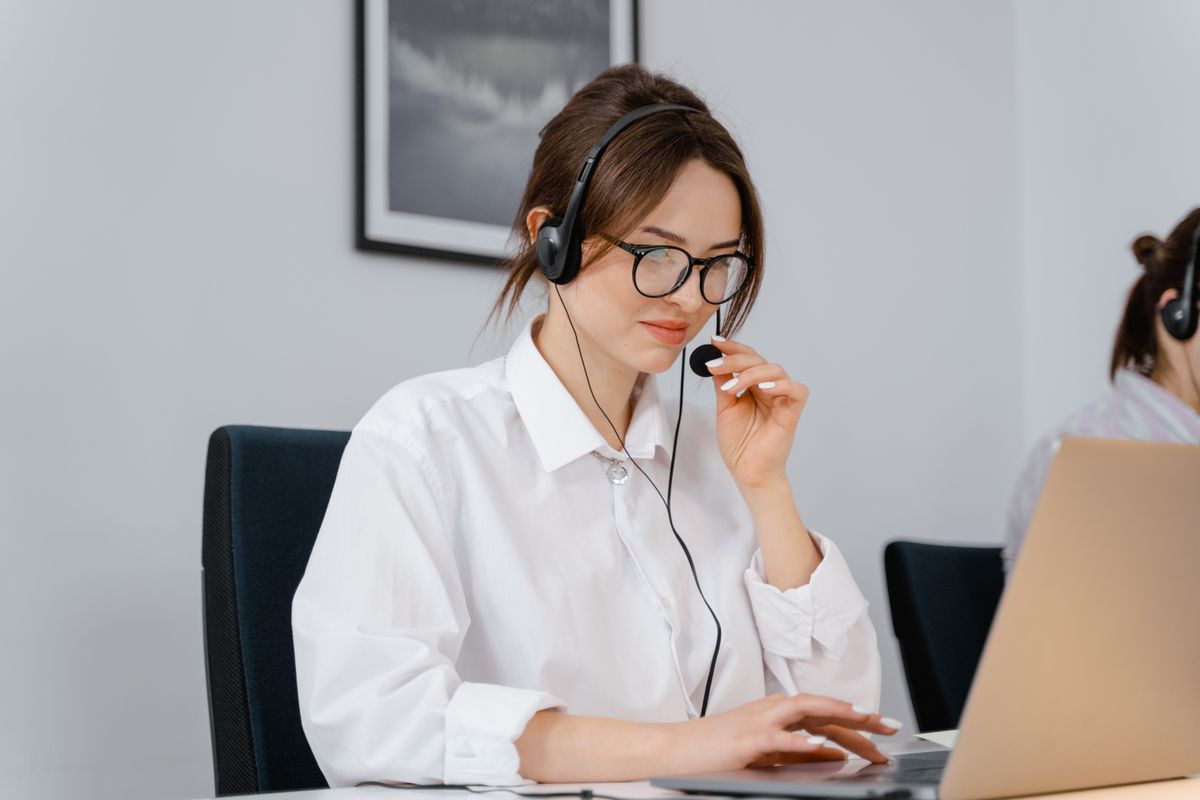 Support agent reviewing customer messages on a laptop