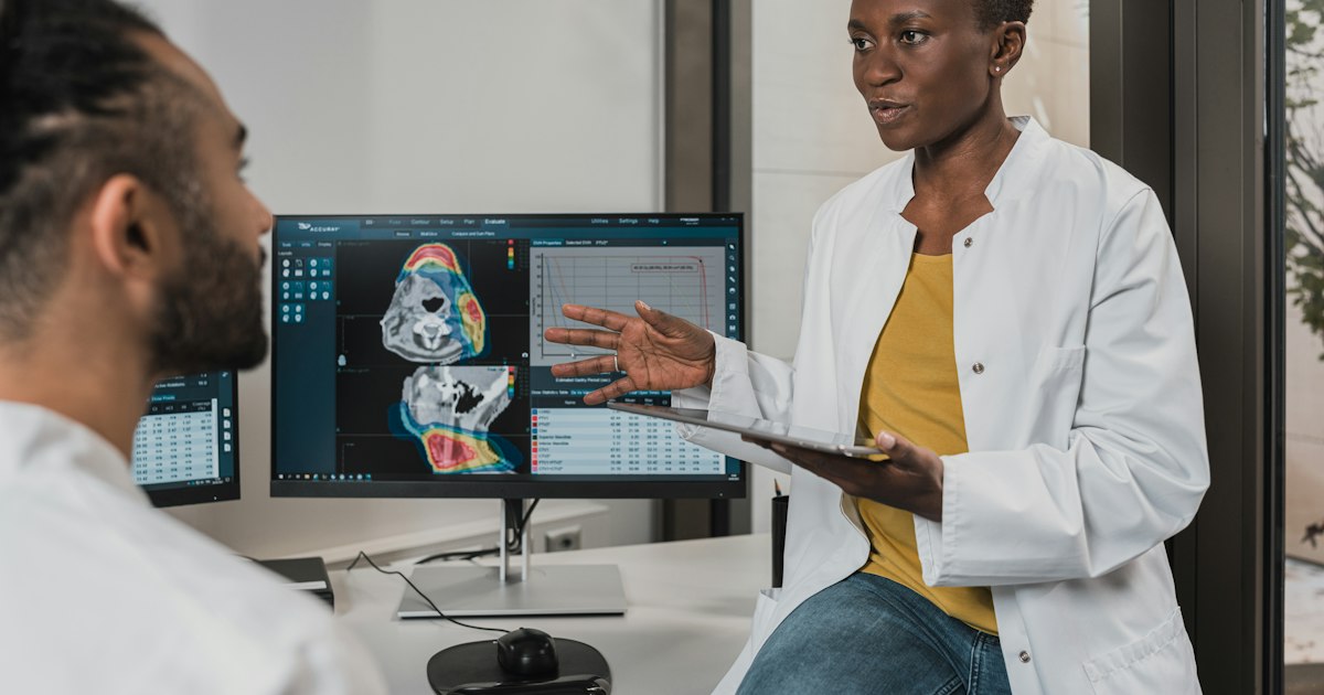 Healthcare professional working with electronic health records at a computer