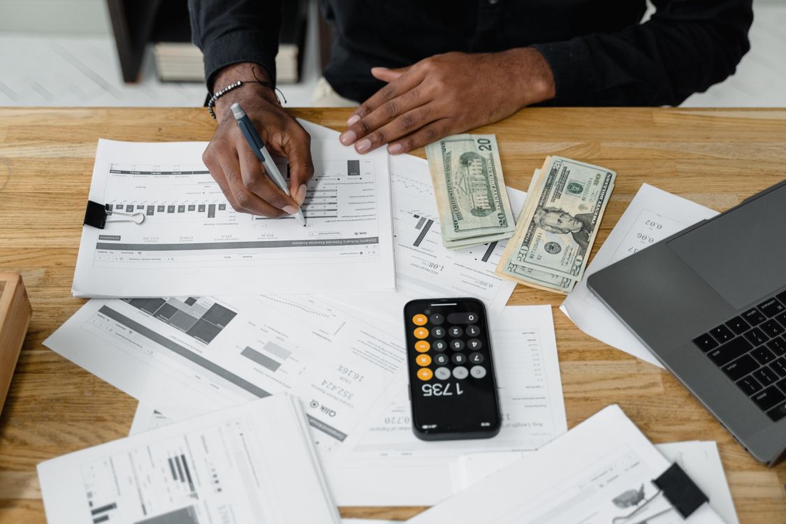 A finance workspace with a laptop, calculator and documents for back office accounting tasks